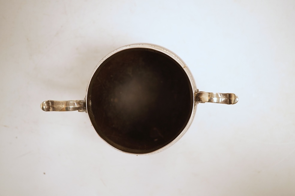 A late 19th/early 20th century white metal mounted two handled coconut cup, with engraved mounts and initials 'A IL', height 10cm (unmarked).
